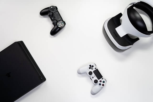 Playstation Console, Two Playstation Controllers and VR Headset on Display.