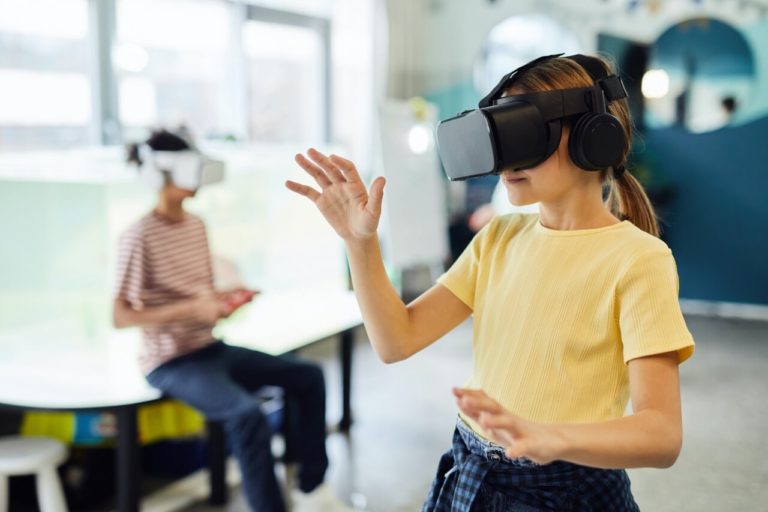 two kids playing with different virtual reality headsets